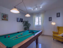 wall, indoor, billiard table, floor, recreation room, pool table, indoor games and sports, billiards, billiard room, blackball (pool), pool, ball, billiard ball, straight pool, english billiards, pocket billiards, room, poolroom, cue stick, ceiling, games, snooker, pool player, baize, sports equipment, living, trick shot
